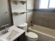 Bathroom featuring a white vanity, toilet, bathtub with tile surround, and three decorative shelves at 1283 Lipan Dr, Denver, CO 80221