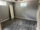 Bedroom with gray walls and wood-look vinyl plank flooring, featuring two windows for natural light at 1283 Lipan Dr, Denver, CO 80221