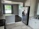 Eat-in kitchen with stainless steel refrigerator and appliances adjacent to dining area at 1283 Lipan Dr, Denver, CO 80221