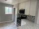 Modern kitchen with stainless steel appliances, white cabinets, and stylish tile backsplash at 1283 Lipan Dr, Denver, CO 80221