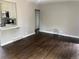 Inviting living room with rich hardwood floors and a view into the adjacent kitchen space at 1283 Lipan Dr, Denver, CO 80221