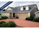 Charming home featuring a brick driveway, two-car garage, dormer windows, and neutral color palette at 21905 E 51St Dr, Aurora, CO 80019