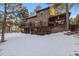 House exterior showcasing backyard and snow at 9673 Huggins Ct, Parker, CO 80134