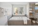 Luxurious bathroom with soaking tub and shelves at 1266 N Gaylord St, Denver, CO 80206