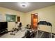 Basement gym area, featuring an open window, gym equipment and ceiling mounted lighting at 3675 S Cherokee St # 710, Englewood, CO 80110