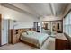 Comfortable bedroom with built-in headboard shelving and balcony at 3675 S Cherokee St # 710, Englewood, CO 80110