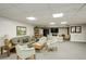 Spacious common room with sofas, chairs, a bookshelf, and a TV at 3675 S Cherokee St # 710, Englewood, CO 80110