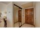 Home entryway with mirror sliding closet and a carved wooden door at 3675 S Cherokee St # 710, Englewood, CO 80110
