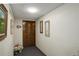 Hallway view with paintings and a carved wooden door at 3675 S Cherokee St # 710, Englewood, CO 80110