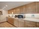 Bright kitchen with oak cabinets and quartz countertop at 3675 S Cherokee St # 710, Englewood, CO 80110