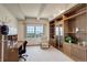 Charming home office with built-in wooden bookshelves, a window with a view, and a comfortable desk and chair at 3675 S Cherokee St # 710, Englewood, CO 80110
