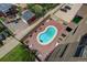 Elevated aerial view of a private kidney-shaped outdoor pool surrounded by a brick patio and lounge chairs at 3675 S Cherokee St # 710, Englewood, CO 80110
