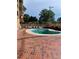 Relaxing pool area with clear water, brick pavers, plenty of seating, and charcoal grills ready for outdoor entertaining at 3675 S Cherokee St # 710, Englewood, CO 80110
