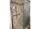 Modern shower featuring attractive marble-patterned tile, glass door, shower bench, and grab bar for safety at 3675 S Cherokee St # 710, Englewood, CO 80110