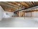 Spacious unfinished basement with concrete floor and visible ceiling beams, ready for customization at 534 Stonemont Dr, Castle Pines, CO 80108