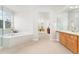 Bright bathroom with soaking tub, dual sink vanity, and a tiled shower stall at 534 Stonemont Dr, Castle Pines, CO 80108