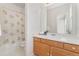 Cozy bathroom with single sink vanity and shower-tub combo with curtain at 534 Stonemont Dr, Castle Pines, CO 80108