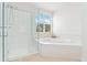 Bright bathroom featuring a glass enclosed shower and corner soaking tub with jets at 534 Stonemont Dr, Castle Pines, CO 80108