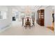 Elegant dining room with a chandelier, wainscoting, and a large china cabinet, perfect for formal dinners at 534 Stonemont Dr, Castle Pines, CO 80108