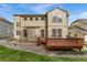 Back of house, showcasing a wooden deck and well-maintained yard at 534 Stonemont Dr, Castle Pines, CO 80108