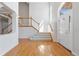 Inviting foyer showcasing gleaming hardwood floors, a staircase, and a grand entrance, offering a warm welcome at 534 Stonemont Dr, Castle Pines, CO 80108