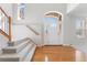 Bright foyer with hardwood floors, staircase, and a view of the front entrance, highlighting the open space at 534 Stonemont Dr, Castle Pines, CO 80108