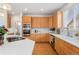 Well-lit kitchen with stainless steel appliances, an island cooktop, and light wood cabinets, great for cooking at 534 Stonemont Dr, Castle Pines, CO 80108