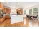 Bright eat-in kitchen featuring an island, stainless steel appliances, wood floors and modern lighting at 534 Stonemont Dr, Castle Pines, CO 80108