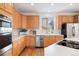 Bright kitchen featuring quartz countertops, stainless steel appliances, and light wood cabinets, great for cooking at 534 Stonemont Dr, Castle Pines, CO 80108