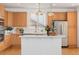 Modern kitchen with stainless steel appliances, a central island, and light wood cabinetry, perfect for cooking at 534 Stonemont Dr, Castle Pines, CO 80108