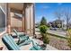 Cozy front porch with blue Adirondack chairs and landscaping, perfect for relaxing outdoors at 534 Stonemont Dr, Castle Pines, CO 80108