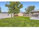A large backyard with lawn, garden box, shed, and covered patio at 5090 Tejon St, Denver, CO 80221