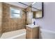 Cozy bathroom with updated vanity, modern fixtures and tiled shower/tub combo at 5090 Tejon St, Denver, CO 80221