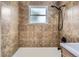 Bathroom featuring a tiled shower/tub combo and bright window for natural light at 5090 Tejon St, Denver, CO 80221