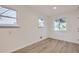A well-lit bedroom with wood flooring, large windows, and modern neutral paint at 5090 Tejon St, Denver, CO 80221