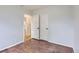 An empty bedroom with hardwood floors, closet, and an adjoining room at 5090 Tejon St, Denver, CO 80221
