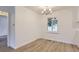 Cozy dining area featuring new flooring, a modern chandelier, and ample natural light at 5090 Tejon St, Denver, CO 80221