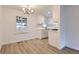 Bright dining room with wood-style flooring, a stylish light fixture, and neutral walls at 5090 Tejon St, Denver, CO 80221