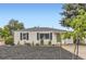 Charming single-story home with a green door and landscaping at 5090 Tejon St, Denver, CO 80221