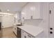Bright kitchen boasts white cabinetry, stainless steel appliances, and a functional layout at 5090 Tejon St, Denver, CO 80221
