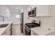 Modern kitchen features white cabinets, stainless steel appliances, and sleek countertops at 5090 Tejon St, Denver, CO 80221
