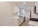 Bright kitchen with white cabinets, stainless steel appliances, and wood-look flooring at 5090 Tejon St, Denver, CO 80221