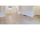 Open living area with wood-look floors and white walls for a clean aesthetic at 5090 Tejon St, Denver, CO 80221