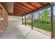 Covered patio with a brick wall, open storage space, and a view of the lawn at 5203 Scranton St, Denver, CO 80239