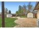 Backyard with an outdoor storage sheds, a fire pit, and stone patio at 5203 Scranton St, Denver, CO 80239