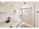 Modern bathroom featuring a quartz countertop, black hardware, and a tiled walk-in shower at 5203 Scranton St, Denver, CO 80239
