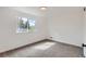 Clean bedroom featuring a large window providing natural light, and plush carpeting at 5203 Scranton St, Denver, CO 80239