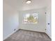 Comfortable bedroom featuring a large window offering ample natural light and plush carpeting at 5203 Scranton St, Denver, CO 80239