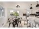Bright dining area with a modern table setting and views, connected to a stylish kitchen with bar seating at 5203 Scranton St, Denver, CO 80239