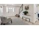Welcoming entryway with white trim, hardwood floors, black and white rug and a modern staircase at 5203 Scranton St, Denver, CO 80239